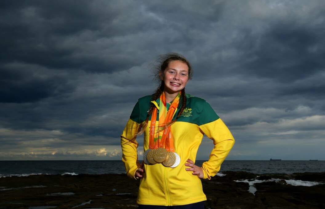 GOLDEN GIRL: The storm clouds over the Hunter had a gold and silver lining when Maitland's Paralympic swimming champion arrived home with her swag of medals on Thursday. Picture: Jonathan Carroll