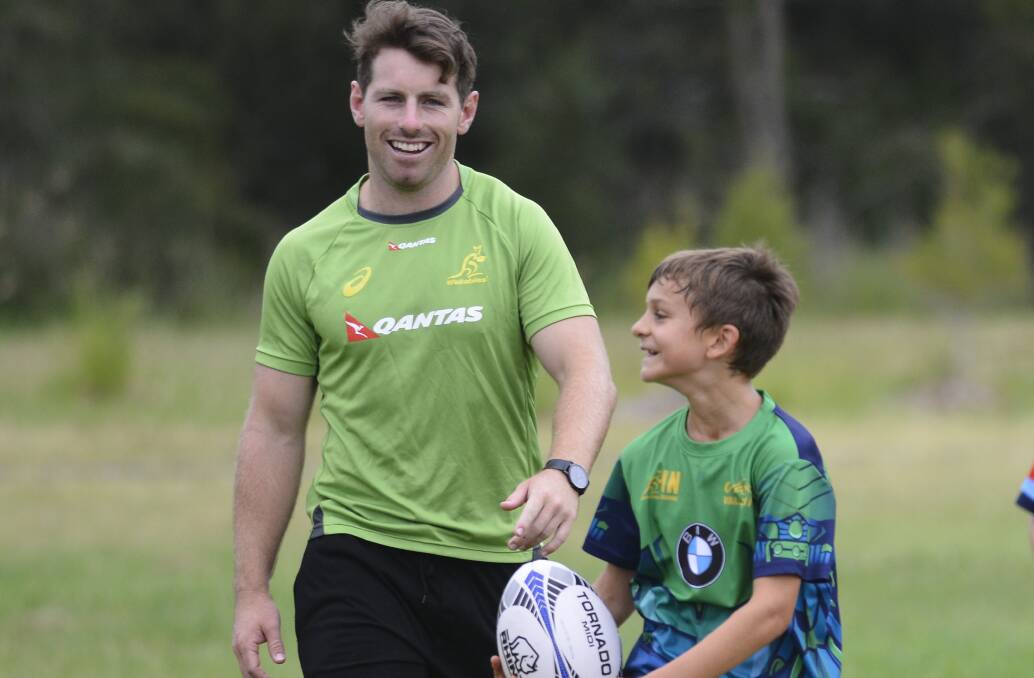 Wallabies star Bernard Foley with a young rugby enthusiast. Picture: Michael Hartshorn