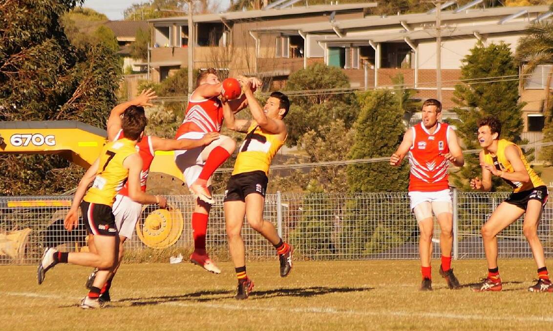 TOUGH CONDITIONS: Maitland Saints forward Wade Beard takes a mark against Singleton Roosters. Picture: Rick Merrick