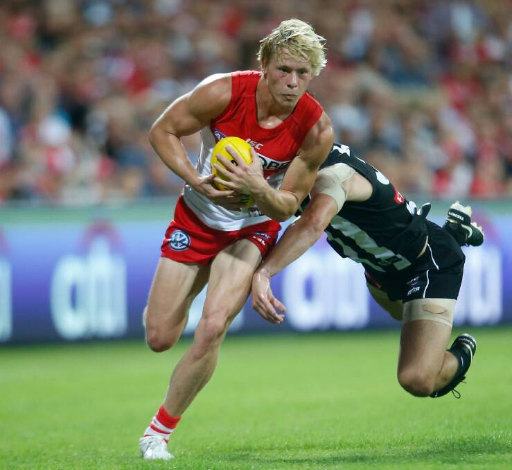 CAN'T CATCH HIM: Sydney Swans star Isaac Heeney breaks a tackle before launching another attack in the Swans' 80-point round one victory.