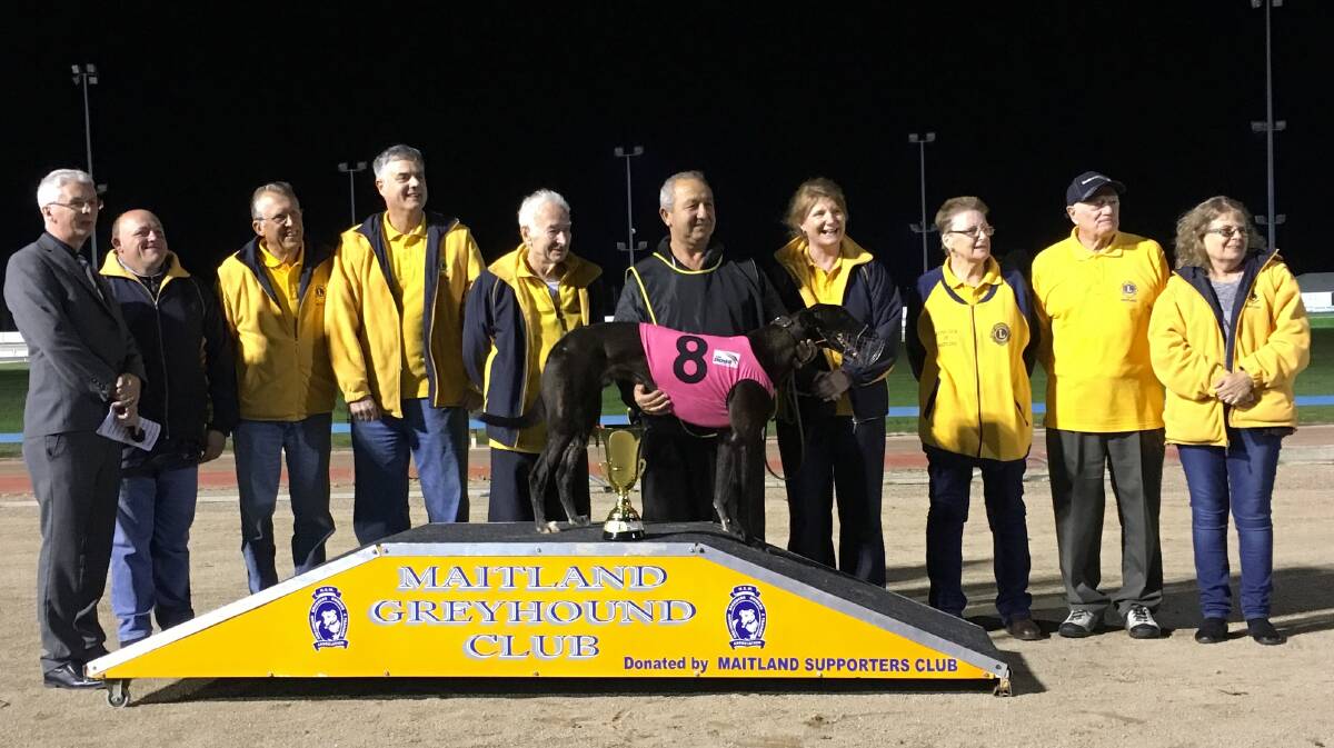 LIONS TRIBUTE: Col Emery with handler Sam Sultana and race winner Cannikin and Lions Club members after the race named in Emery's honour. Picture: Supplied.

