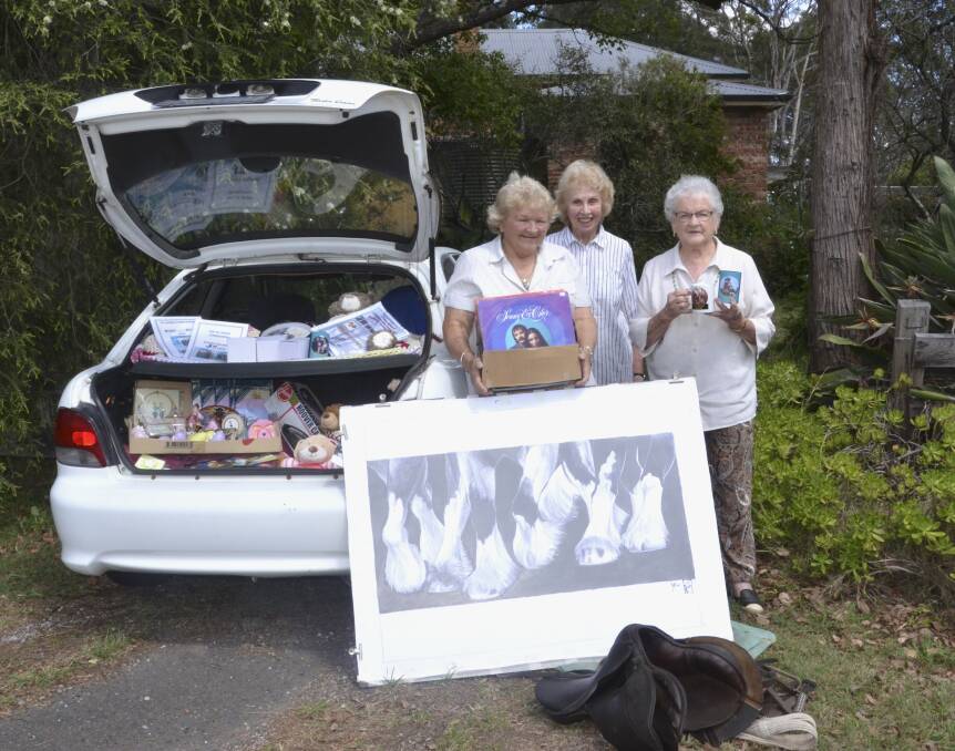 COMMUNITY DAY: Owner of the former Buchanan Gallery, Janet O'Donnell (centre) and Pit Horse Statue Project committee members Fay Thorpe and Mary Holdom with some of the items up for grabs at the car boot sale.