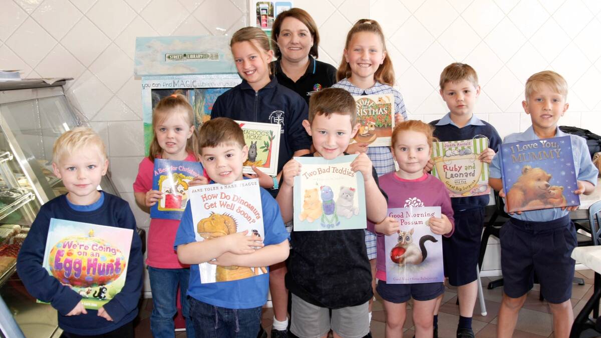 PROMOTING LITERACY: Branxton Preschool director Natalie Caslick with local preschoolers and school children at the Street Library inside Le's Bakery. Picture: supplied