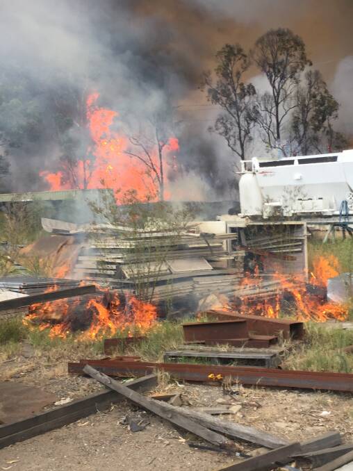 SCARE: A paint spray booth and ventilation ducting alight at Solid Engineering in Mitchell Avenue, Kurri Kurri during the bushfire on Wednesday. Picture: supplied