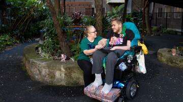 Ann and Cameron McCallum in John Hunter Hospital's fairy garden. Cameron has been in hospital for more than 475 days. Picture by Jonathan Carroll    
