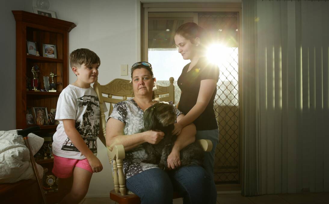 Life Changing: Renae Nichols suffered several strokes after being the victim of a car accident. She's pictured with her children Nikkita, 12, and Jessinta, 17, and their dog Cocoa. Picture: Marina Neil. 