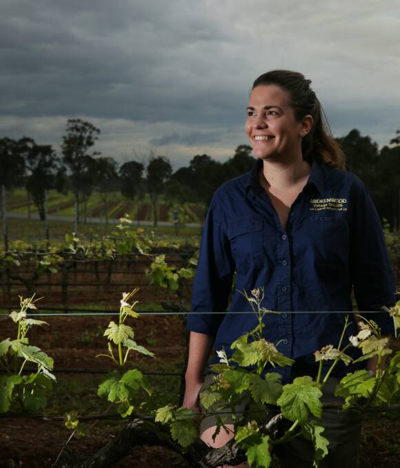 BLOOMING: Brokenwood Wines' assistant winemaker Kate Sturgess among the vines, which look to be shaping up for a quality vintage. Picture: Simone De Peak 