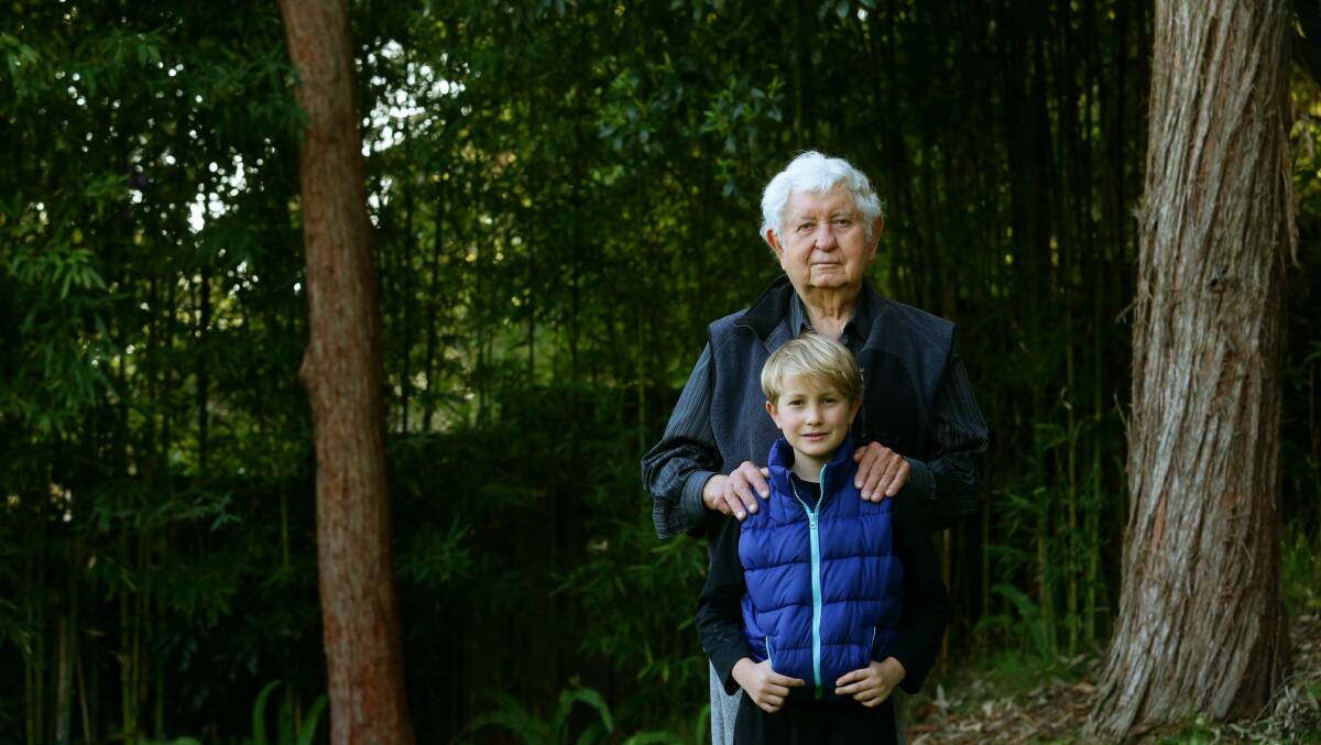 VICTORY: Vitaly (Victor) Lupish pictured at his Rankin Park home with grandson Aidan Hadley. PICTURE: Jonathan Carroll.