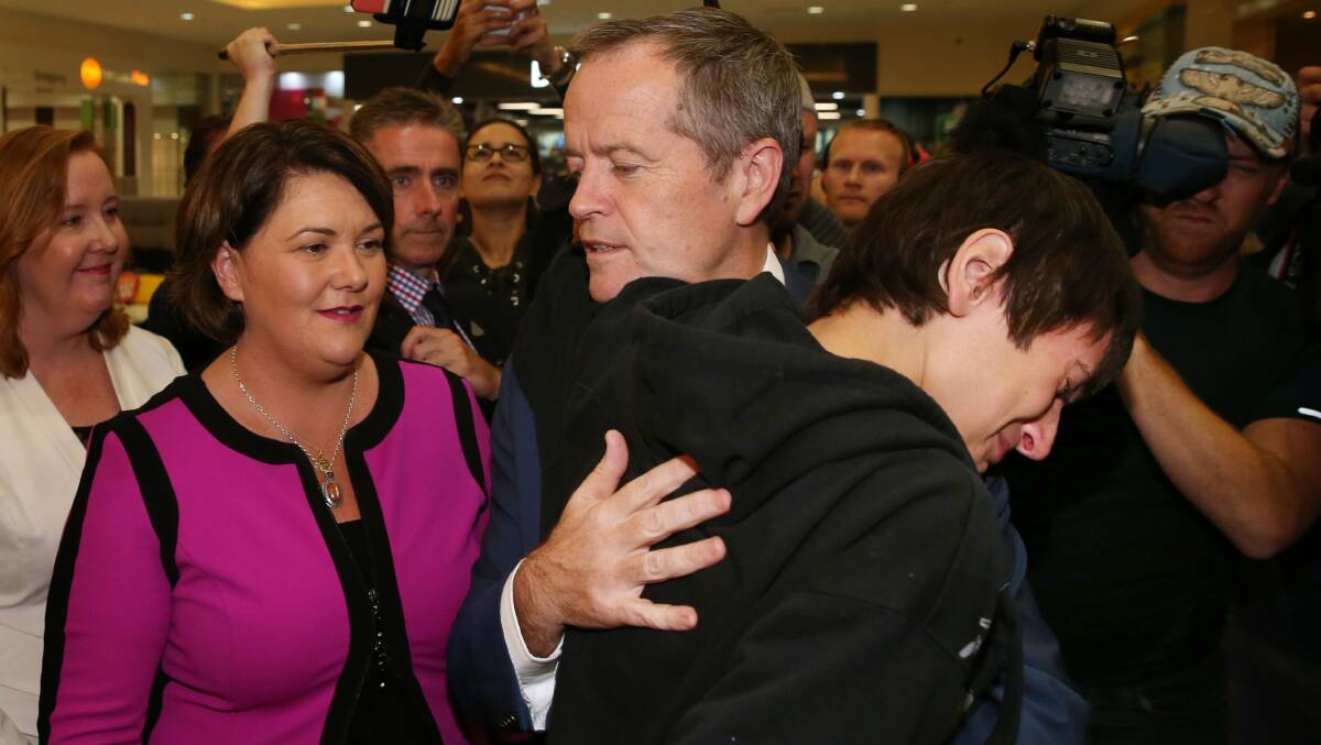 CAMPAIGN: Opposition leader Bill Shorten comforts 17 year old local Christian Le Cedergren who broke into tears when talking to the politician. Picture: MAX MASON-HUBERS 