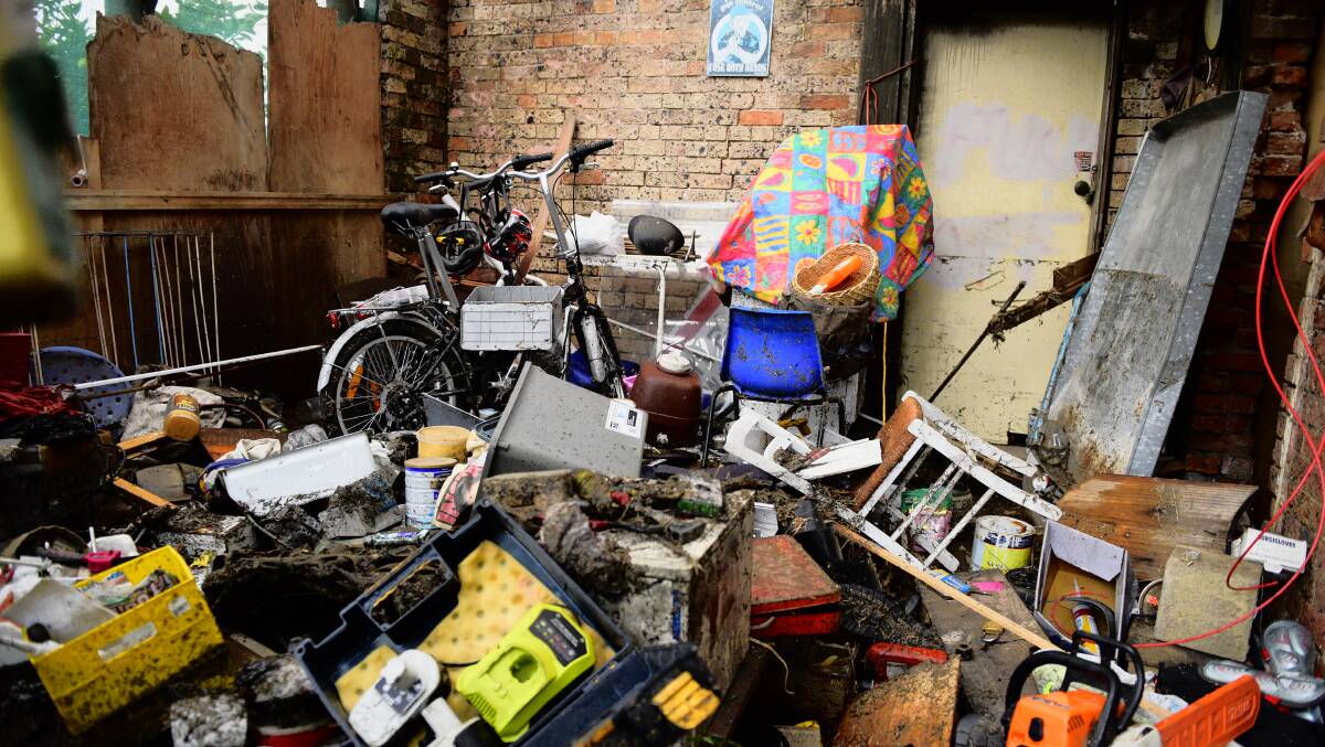 DAMAGE: Belongings piled into a room after the super storm swept through the house.