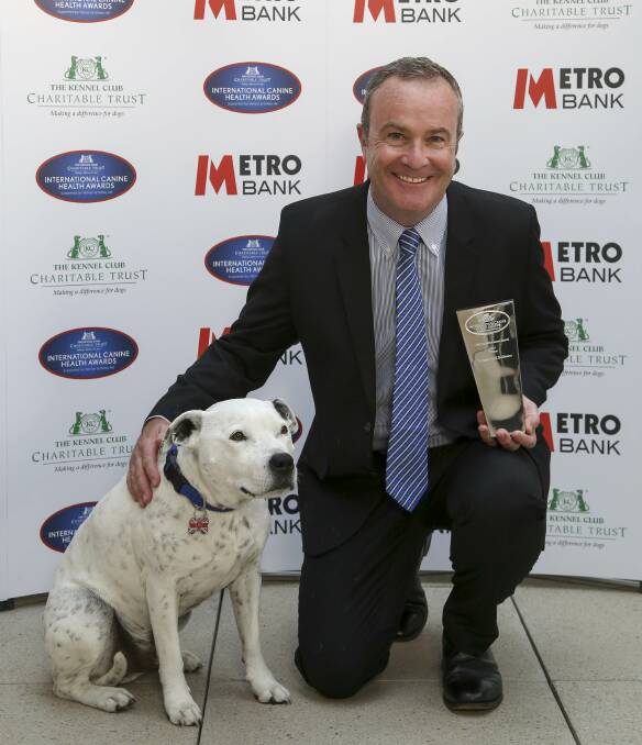 HAPPY: Professor Paul McGreevy with his award and a four-legged friend at the International Canine Health Awards. Picture: supplied.
