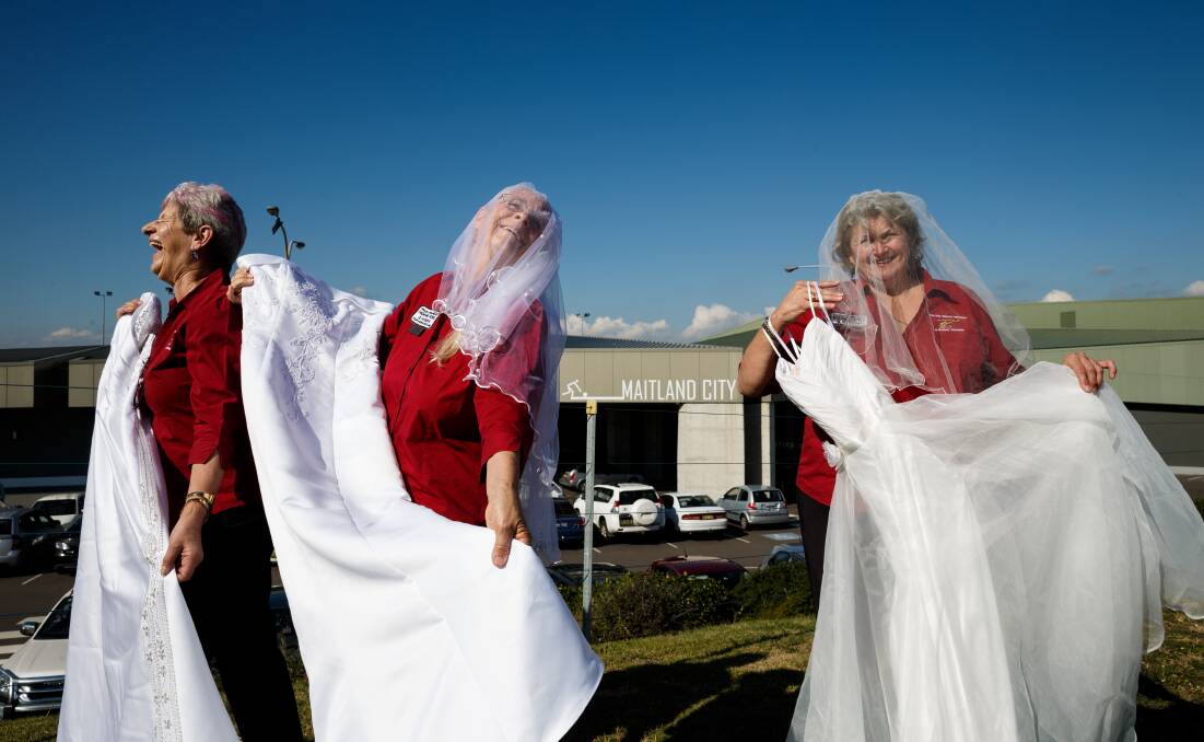 EXPO: Westpac Rescue Helicopter Maitland Support Group volunteers Margaret Kirkwood, Virginia Milne and Cathy Leary pose with bridal wear to promote their wedding expo. Picture: Max Mason-Hubers