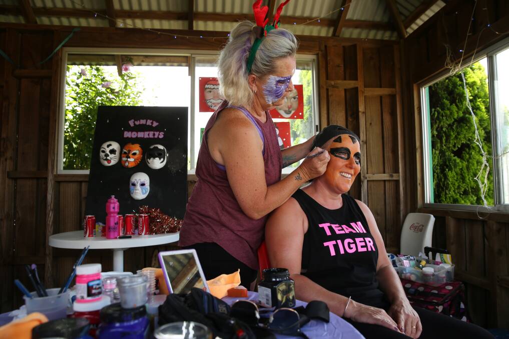 FUNDRAISING CHAMPION: Linda Bullent having her face painted by Mel Edwards at the fun day fundraiser she held for cancer research. Picture: Max Mason-Hubers