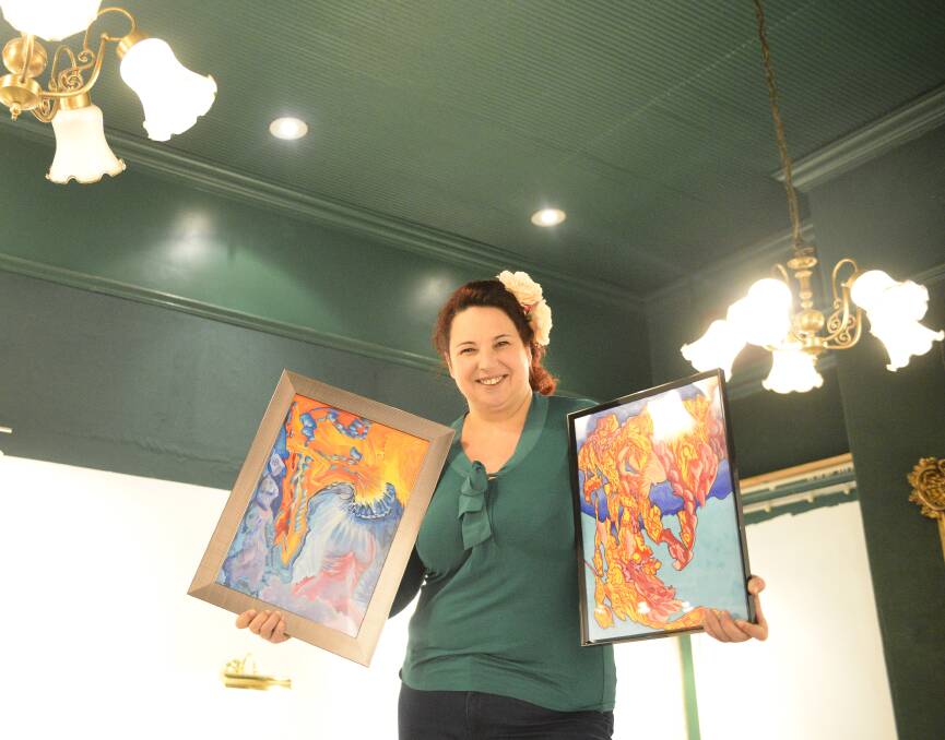 ART SAVED MY LIFE: Artist  Sonja Elise with two of her works in one of the viewing rooms at the Old George and Dragon in East Maitland, which is now home to the Hunter Artisan Gallery and Cafe. Picture: Belinda-Jane Davis