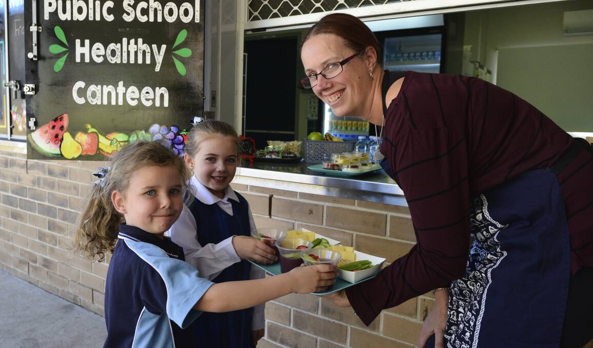 HEALTHY: Morpeth Public School canteen manager Rebecca Buehler with students Khloe Fidock, 6, and Lilah Smith, 5. Picture: Belinda-Jane Davis