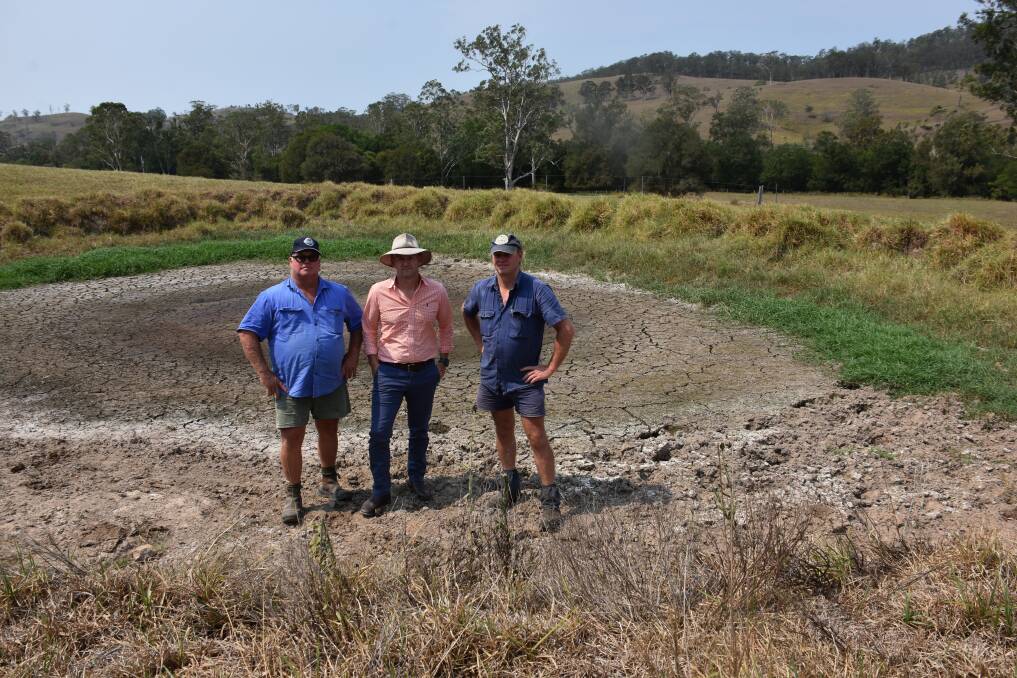VISIT: Fourth-generation dairy farming cousins Bill Williams and Rod Williams with NSW Primary Industries and Water Resources Minister Niall Blair (centre) in a dry dam at Stroud. Picture: Belinda-Jane Davis