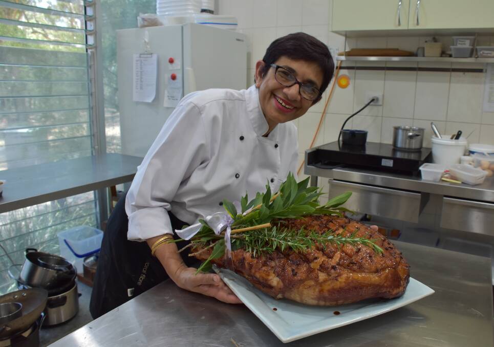 MERRY CHRISTMAS: Chef Amorelle Dempster in her kitchen with a raspberry-glazed ham. Picture: Belinda-Jane Davis