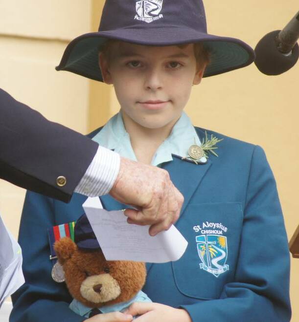 MEMENTO: Zac Seaton with Daddy Bear at Morpeth on Anzac Day.