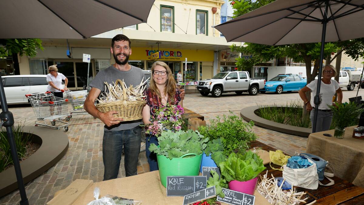 LIVING THE DREAM: Boutique farmers Tom Christie and Dominique Northam with some of their wares at the market in Maitland's The Levee. Picture: Jonathan Carroll.