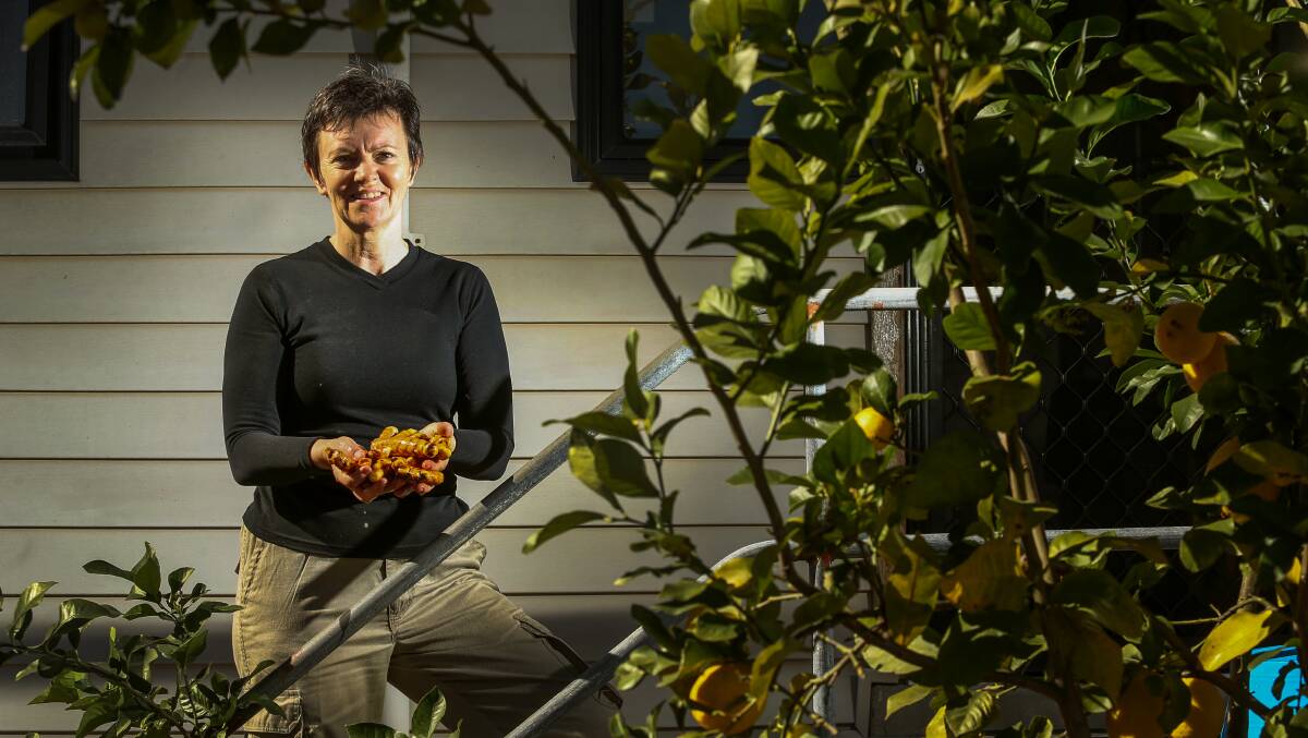 HOOKED: Liz Griffiths, of Telarah, with some of the turmeric she grows in her backyard. Picture: Marina Neil.  