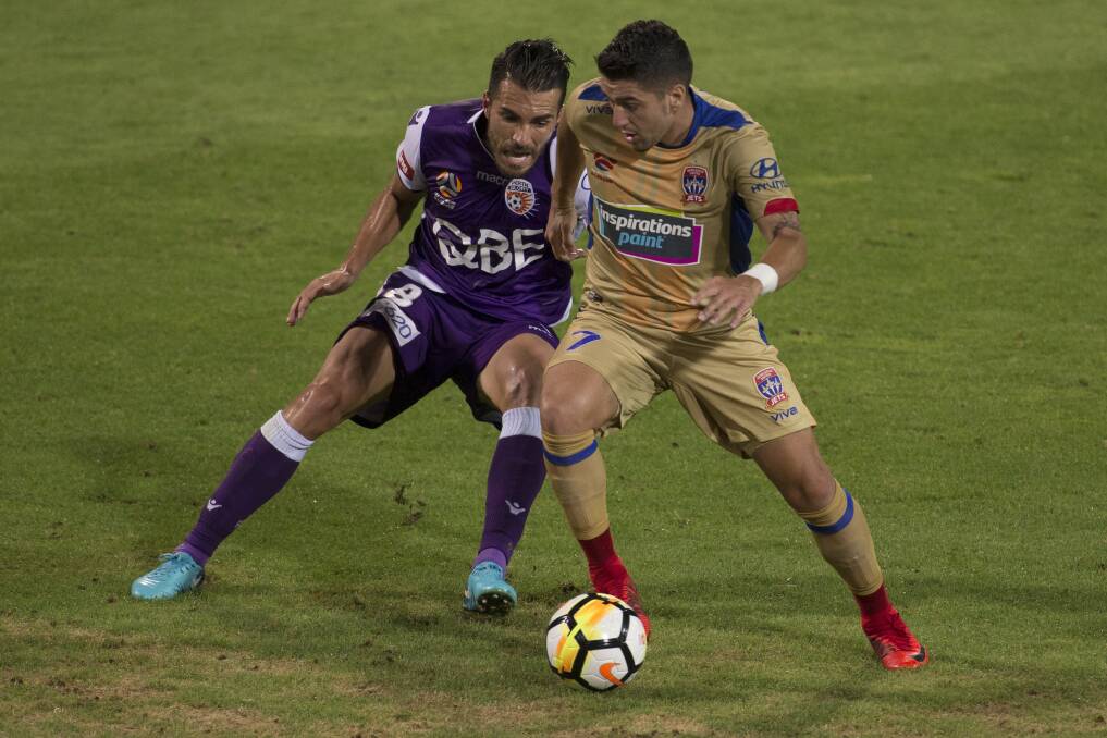 CONTACT: Xavi Torres of the Glory tries to tackle Newcastle's Dimitri Petratos in Saturday's clash at nib Stadium. Picture: AAP