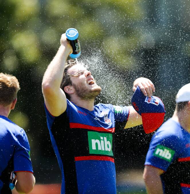 SWEAT SESSION: Lachlan Fitzgibbon cools off at training. Picture: Jonathan Carroll