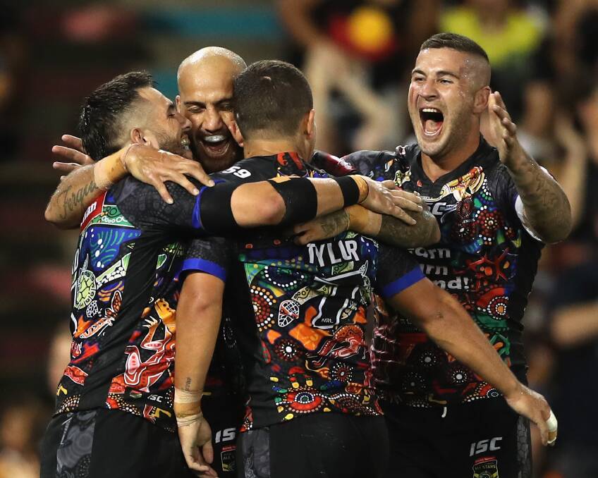 TRY TIME: The Indigenous All Stars celebrate after Blake Ferguson scores against the World team on Friday night. Picture: Getty Images