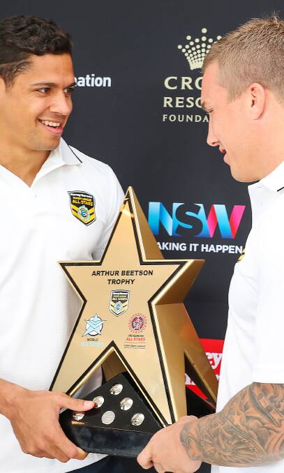 STAR POWER: Knights Dane Gagai and Trent Hodkinson with the Arthur Beetson Trophy in Newcastle on Wednesday.