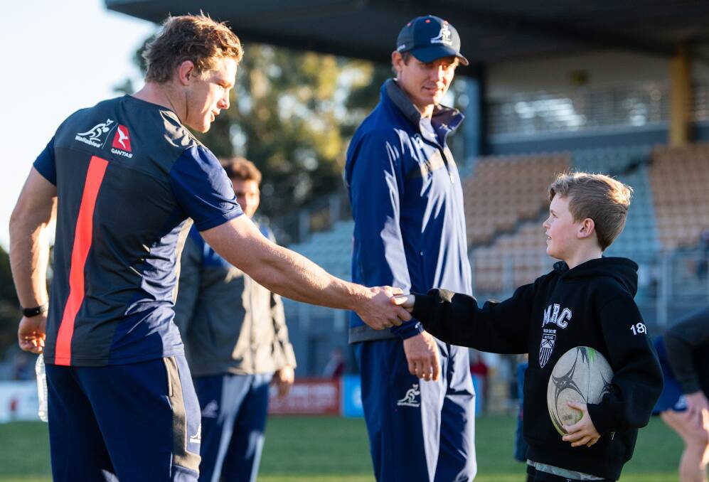 MEET AND GREET: Wallabies captain Michael Hooper shakes hands with a Maitland junior at a clinic at Cessnock Sportsground on Monday. The Wallabies are spending four days in camp in Cessnock. Picture:Stu Walmsley/RugbyAU Media