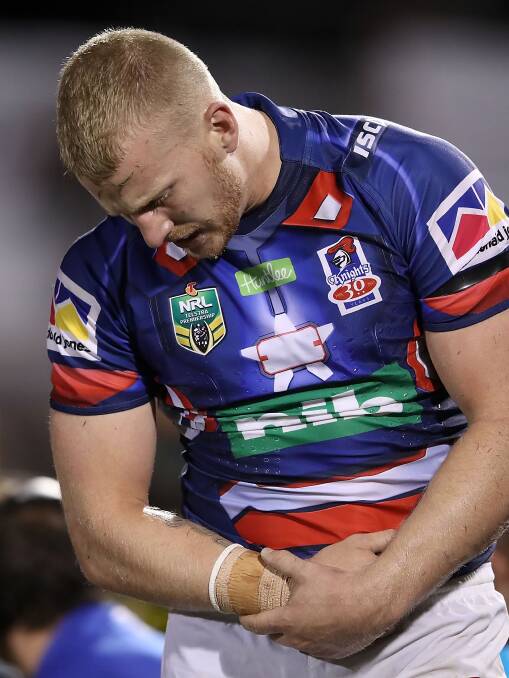 IN DOUBT: Mitch Barnett nurses his right shoulder after receiving a knock in the Knights 40-0 loss to Penrith. Picture: Getty Images