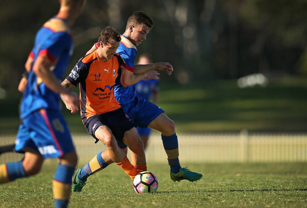 WORK HORSE: Matt Paul battles Jackson Frendo for possession on Saturday. His first-half strike was enough to secure Valentine a 1-0 win over the Newcastle Jets Youth team at Cahill Oval. Picture: Marina Neil