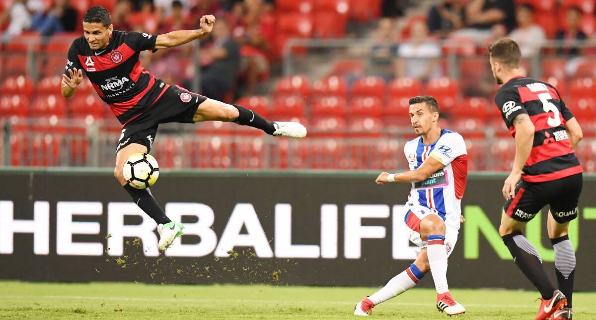 ON THE BALL: Jets defender Daniel Georgievski fires a cross past Wanderers midfielder Marcelo Carrusca in the controversial 2-all draw at Spotless Stadium on Friday night. Pictures: AAP 