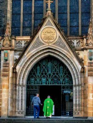 A priest at St Patrick's Cathedral on Sunday. Photo: Luis Ascui