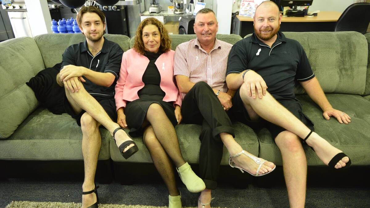 GOOD CAUSE: Radio Rentals Maitland staff Nigel Lewis, Dean Houlahan and Josh Hartley with Maitland Mayor Loretta Baker for the store's Wear a Pair campaign. Picture: Sage Swinton