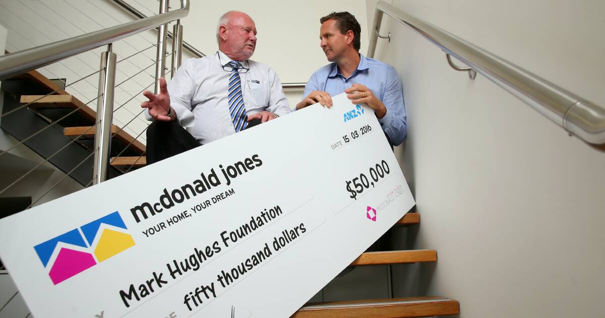SUPPORT: McDonald Jones Homes director Bill McDonald presents $50,000 to Mark Hughes of the Mark Hughes Foundation. Photo by Max Mason-Hubers.
