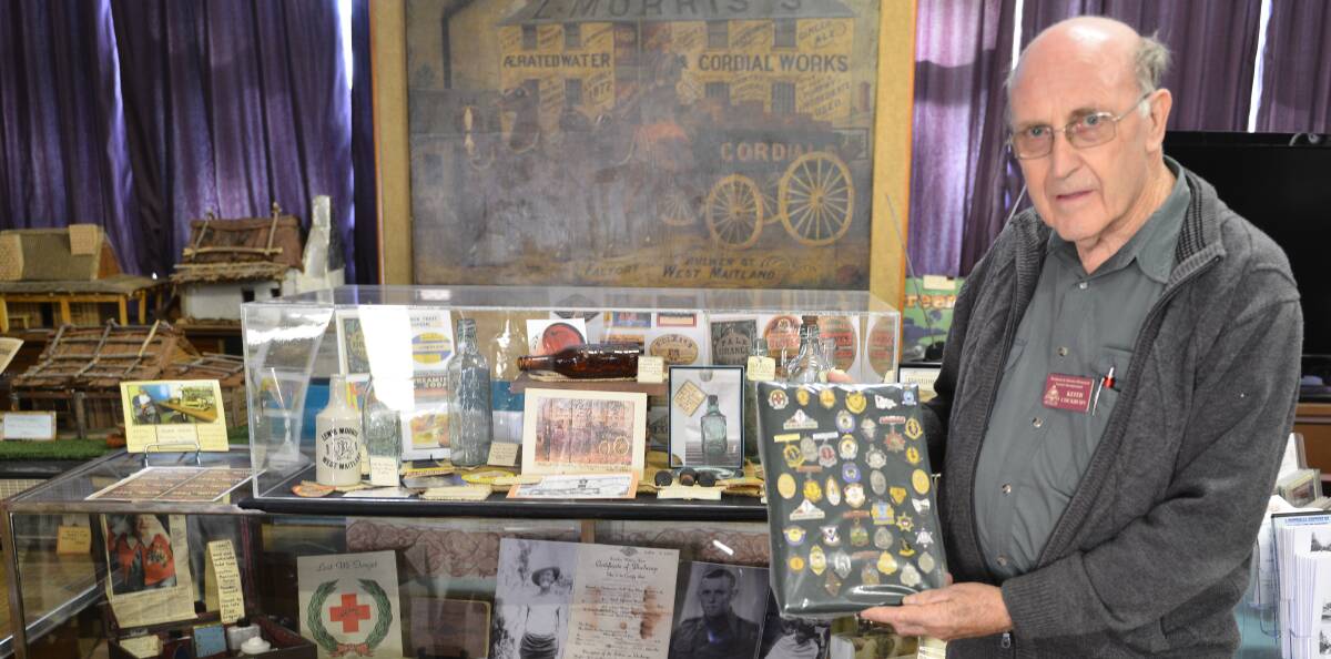 MEMORABILIA: Maitland and District Historical Society president Keith Cockburn with the marching band badges and other items that will be on display at the open day.