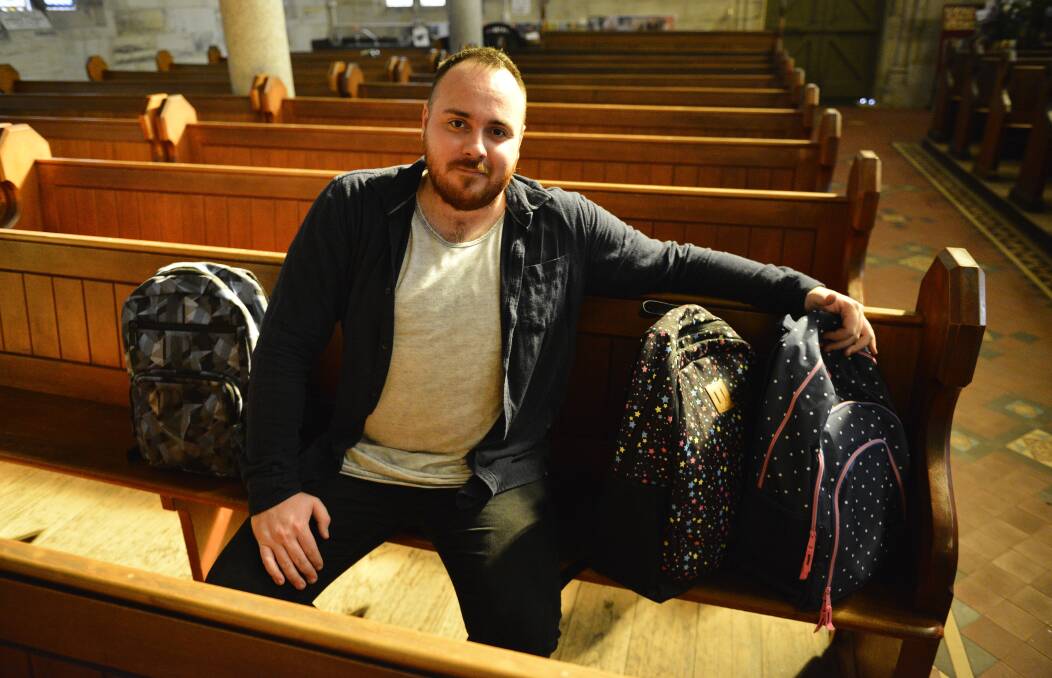 ASSISTANCE: St Peter’s Anglican Church parish ministry apprentice Jesse Poole with the backpacks. Picture: Sage Swinton