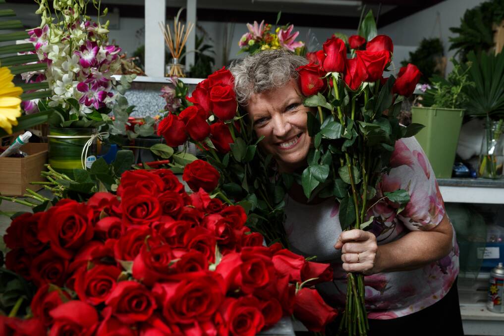 ROMANTIC: East Maitland Florist owner Annette Moss with some red roses ahead of Valentine's Day. Picture: Max Mason-Hubers