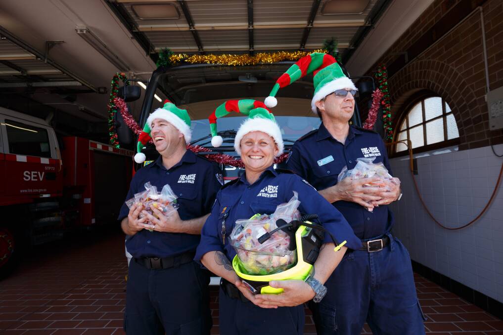 CHRISTMAS CHEER: Maitland Fire and Rescue retained firefighters Matt Knox, Tanya Coxon, and Haydn Carruthers with some of the lollies they will be giving out. Picture: Max Mason-Hubers
