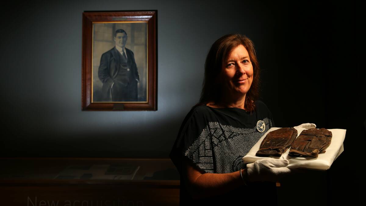 ON DISPLAY: Maitland Regional Art Gallery collection management curator Cheryl Farrell with Les Darcy's gloves. Photo: Max Mason-Hubers.