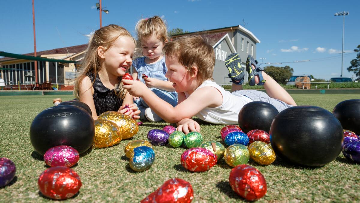 YUM: Chelsea Weiland, 3, Evie Petersen, 2, and Bryce Greay, 3, ahead of Maitland Park Bowling Club's Easter Egg Hunt this Sunday. Picture: Max Mason-Hubers
