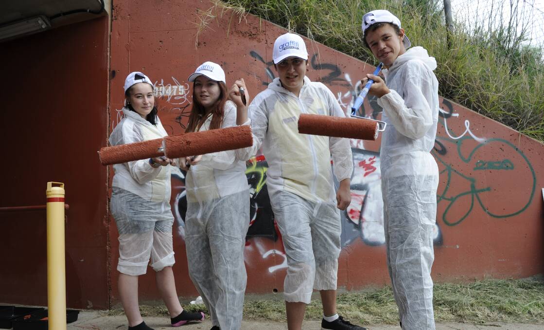 CRUSADE: Interact Club of Rutherford members Emily Kingdom, Tyler Coleman, Tim Hackett and Kieron Bynon cleaning a common graffiti spot in Telarah.