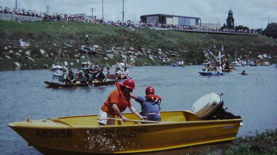 CROWD PLEASER: Crowds lined the banks of the Hunter River to watch the action at one of the raft races in the 1970s. Picture: Sid Bown.