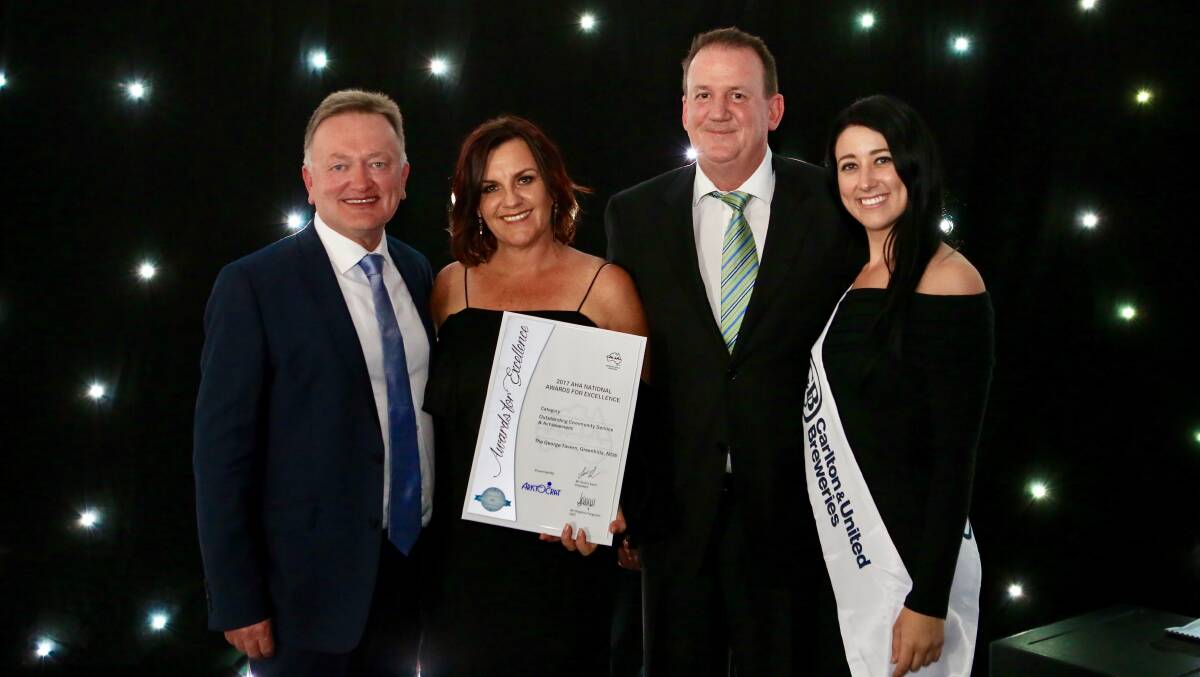 AUSTRALIA'S FINEST: Dan and Janine Redman (left) receive their award from Aristocrat and Carlton United Breweries representatives.