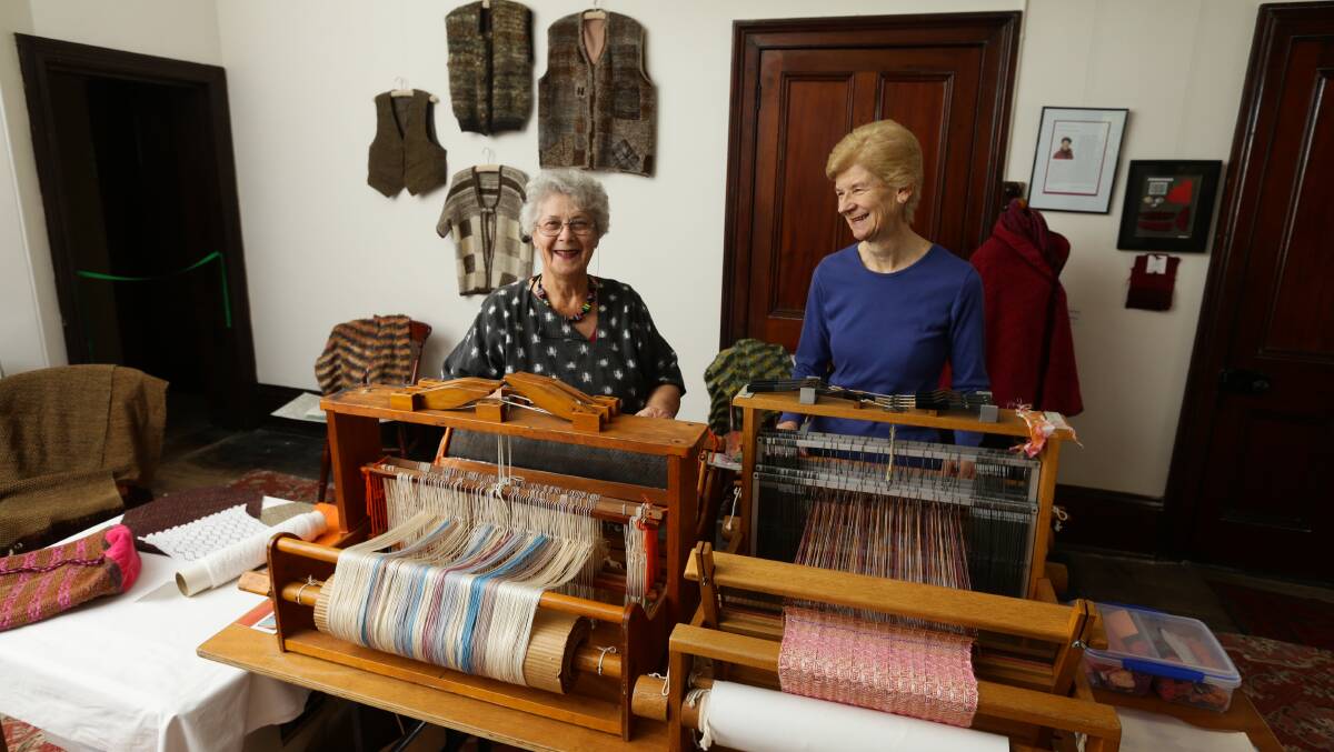 LOOMING SUCCESS: Maitland branch of the Newcastle Spinners and Weavers Guild has had old looms restored which are now operating at Brough House. Picture shows Barbara Osmond and Lynn Morris weaving their magic. Picture: Jonathan Carrol.
