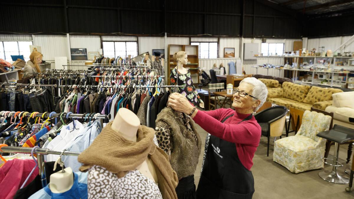 RESURRECTED: Fr Riley's Op Shop has reopened in Lee Street, Maitland. Volunteer Lauraine Whiting is pictured dressing mannequins at the new outlet. Picture: Max Mason Hubers. 