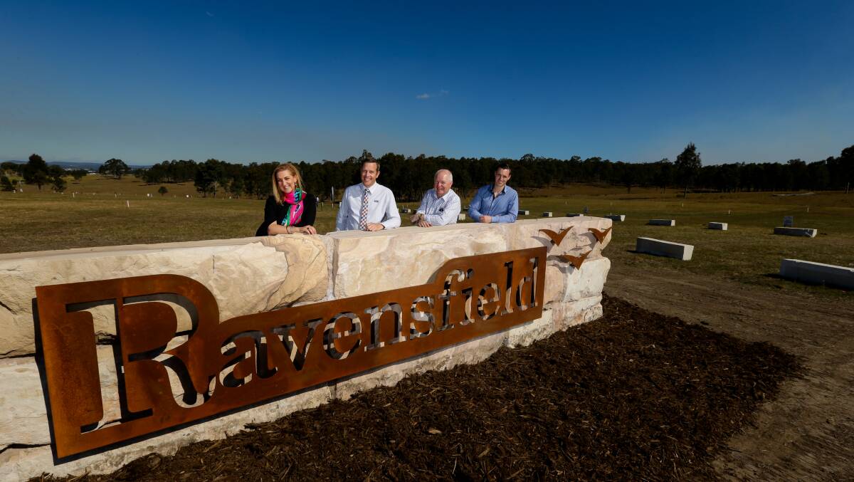 LOTS OF LOTS: Pictured at the new Ravensfield estate at Farley from left, Lisa Simmonds-Webb, Steve Briant, Tim Peters and Jackson Kuczaj. Picture: Jonathan Carroll.