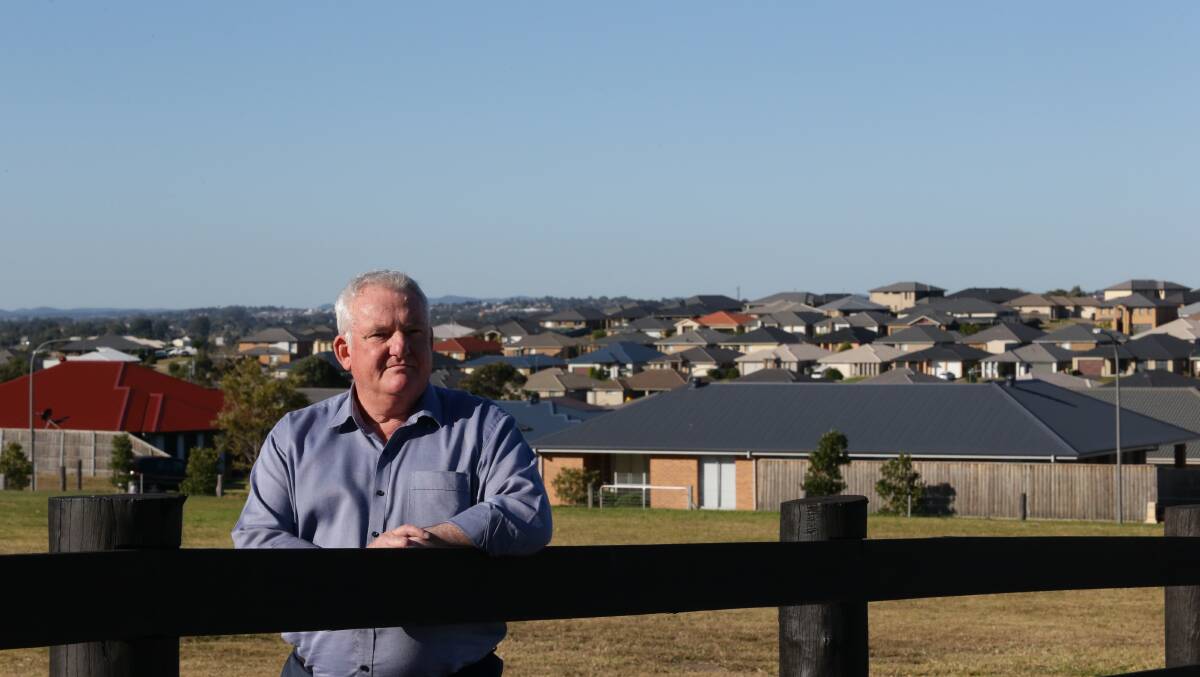 HOMES SWEET HOMES: Maitland City Council's Development and Environment manager David Simm with some of the housing development already underway at Gillieston Heights.