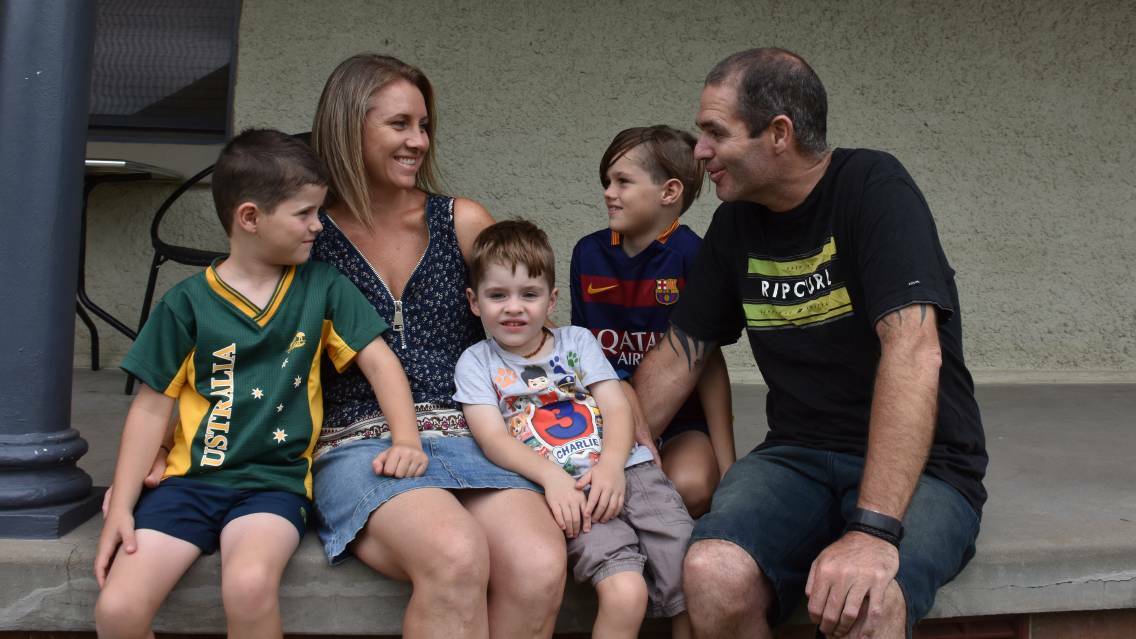READY TO FIGHT: Sebastian (centre) is pictured with his brothers Riley and Preston and his mum and dad Monique and Brett. Picture: Lachlan Leeming.