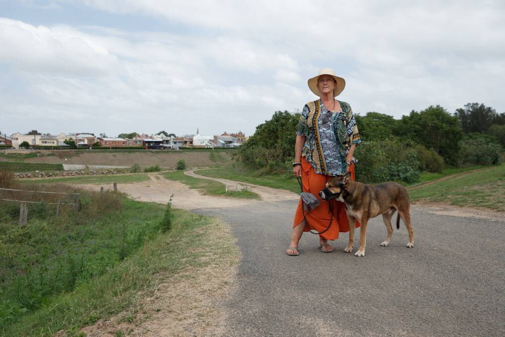 Lorn Action Group spokeswoman Sally O'Neal pictured on the Lorn side of the levee  with her dog Rex. Picture: Max Mason Hubers